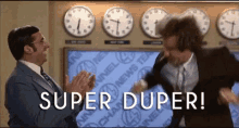 two men are clapping in front of a wall of clocks with the words `` super duper '' written on it .