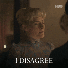 a woman with blonde hair says i disagree in front of a man