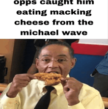 a man in a tie is eating a piece of cheese