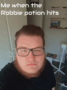 a man with glasses and a beard has the words me when the robbie potion hits above his face