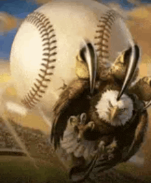 an eagle is holding a baseball with its claws .