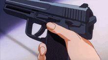 a person is holding a gun in their hand with their finger on the trigger