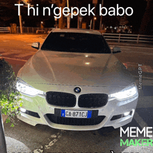 a white bmw with a license plate that says ca 871cj