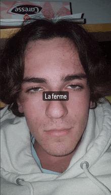 a close up of a man 's face with the word la ferme on his nose