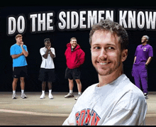 a man stands in front of a poster that says do the sidemen know
