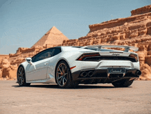 a white lamborghini is parked in the desert