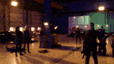 a group of people standing in a room with a sign that says argos