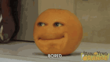 an orange with a face on it and the word bored written below it