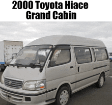 a 2000 toyota hiace grand cabin van is parked on the street