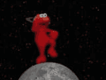 elmo from sesame street is standing on top of a moon in space .