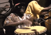 a man in a hat is playing a large drum
