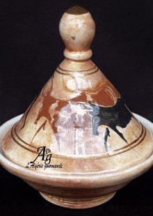 a ceramic bowl with a wooden lid and a painting of a bull on it .