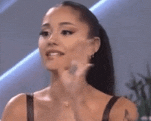 ariana grande is making a funny face while talking to a man .