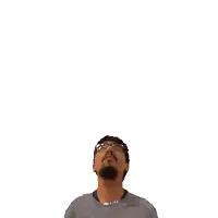 a man with glasses and a beard is looking up at a green cross above his head