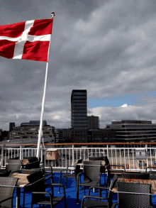 a red white and blue flag is flying on a flag pole