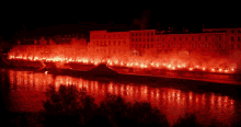 a row of buildings are lit up at night with red lights