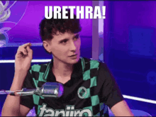 a man sitting in front of a microphone with the words urethra written on the screen