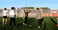 a group of young men are playing soccer on a field with one wearing a shirt that says ' argentina ' on it