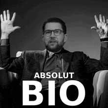 a black and white photo of a man with his hands in the air and the words absolut bio on the bottom