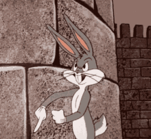 bugs bunny is standing next to a brick wall and pointing at something .