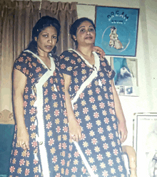 two women are posing in front of a dream poster