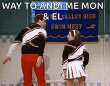 a man and a woman in cheerleading uniforms are standing next to each other in front of a sign that says swim meet .