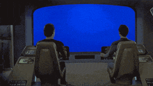 two men are sitting in front of a blue screen that says ' i 'm on the bridge '