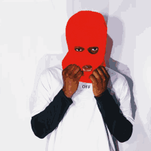 a man wearing a red ski mask and an off shirt