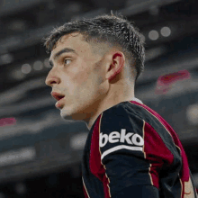 a close up of a soccer player wearing a beko jersey on a field .