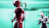 a man in a red and white superhero suit is standing next to another man in a blue suit .