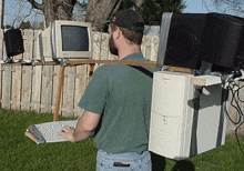 a man carrying a computer on his back with a keyboard