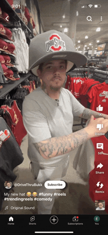 a man wearing a ohio state hat is standing in a store