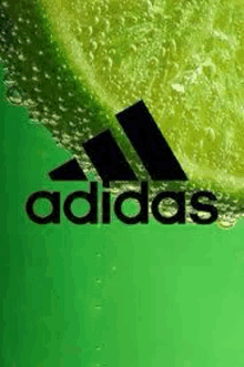 the adidas logo is on a green background with a slice of lime in the background .