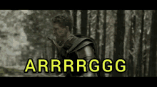 a man in armor is walking through a forest and the words arrrrgg are visible