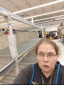 a woman wearing a lanyard that says ghostbusters stands in a store