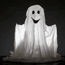 a ghost made out of a sheet with a smiling face .