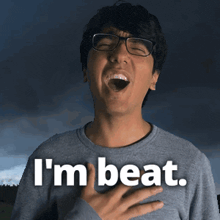 a man wearing glasses and a sweater that says i 'm beat on it