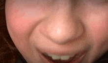 a close up of a person 's face with a smile on it .