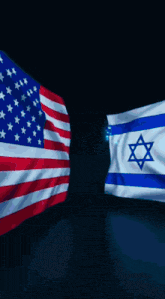 the flags of the united states and israel are flying in the wind
