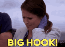 a woman in a white coat and blue gloves is crying and says big hook