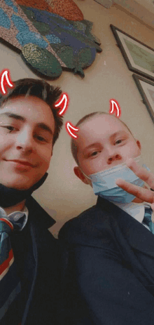 a boy wearing a mask has devil horns on his head