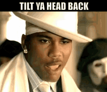 a man wearing a white hat with the words tilt ya head back underneath him