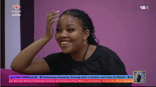 a woman is smiling in front of a purple background that says 18t