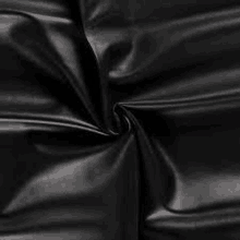 it is a close up of a piece of black leather fabric .