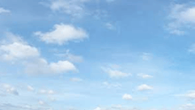 a blue sky with white clouds moving in it