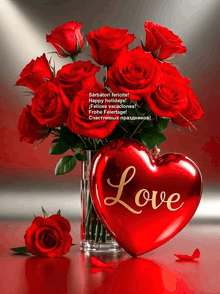 a bouquet of red roses in a vase next to a heart that says love