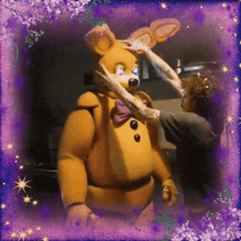 a person petting a stuffed animal with a purple frame around it