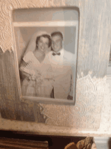 a black and white photo of a bride and groom standing next to each other