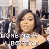 a woman is standing in front of a crowd of people and says `` nonbinary boy bye '' .