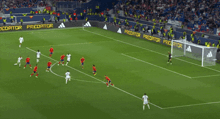 a soccer game is being played in a stadium with a sign that says adidas on it